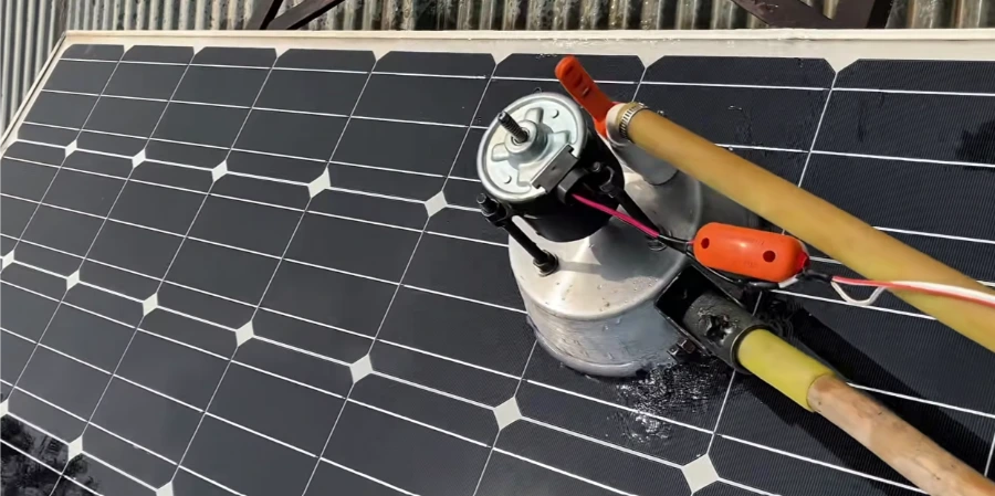 Rotary cleaning brush on an extension pole resting on a solar panel, solar panel cleaning Enterprise NV